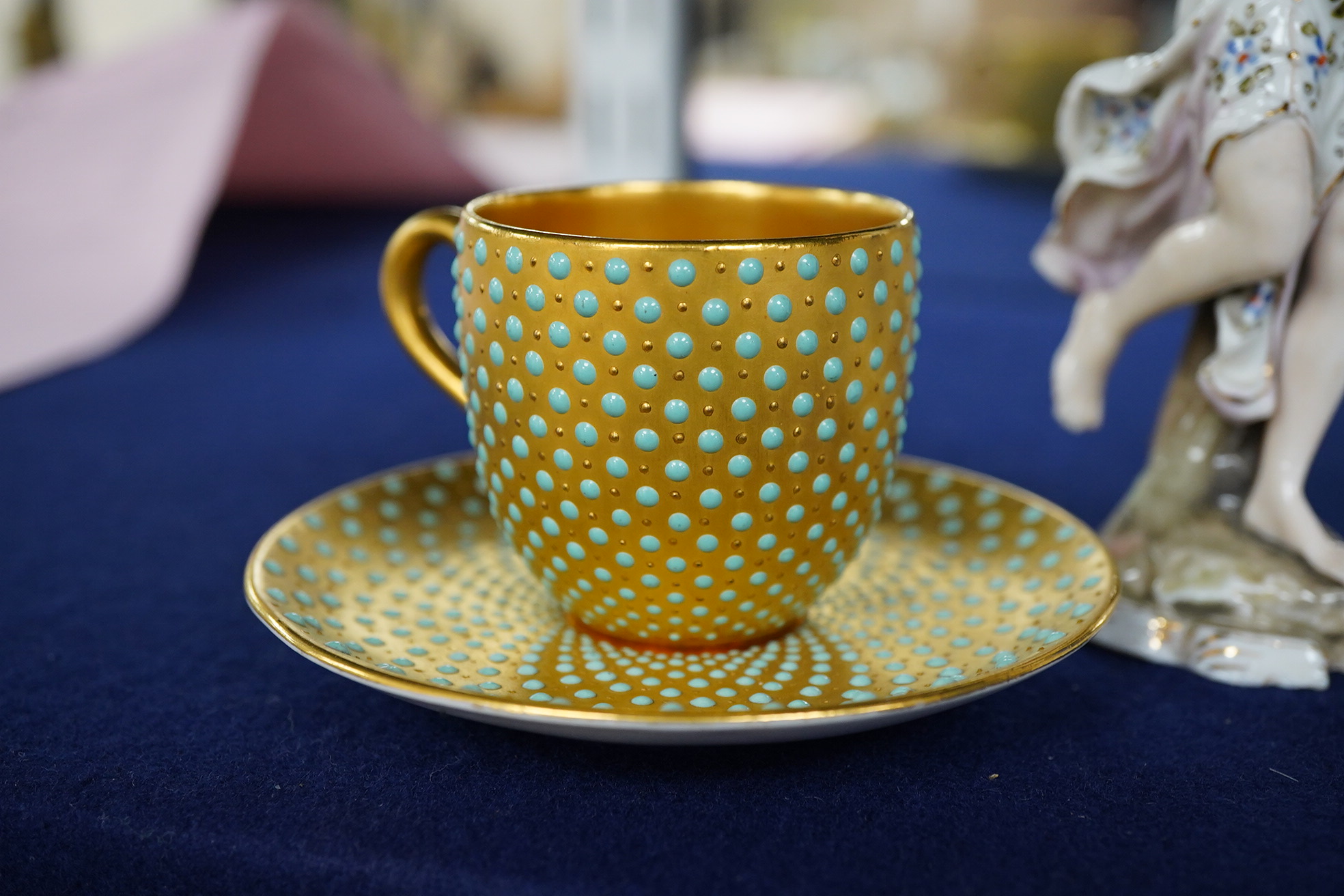 An early 20th century Coalport jewelled cabinet cup and saucer, a Karl Ens grop and a Plane figure